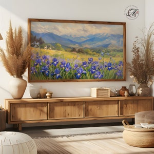 May include: A framed painting of a landscape with a field of purple irises in the foreground and a mountain range in the background.