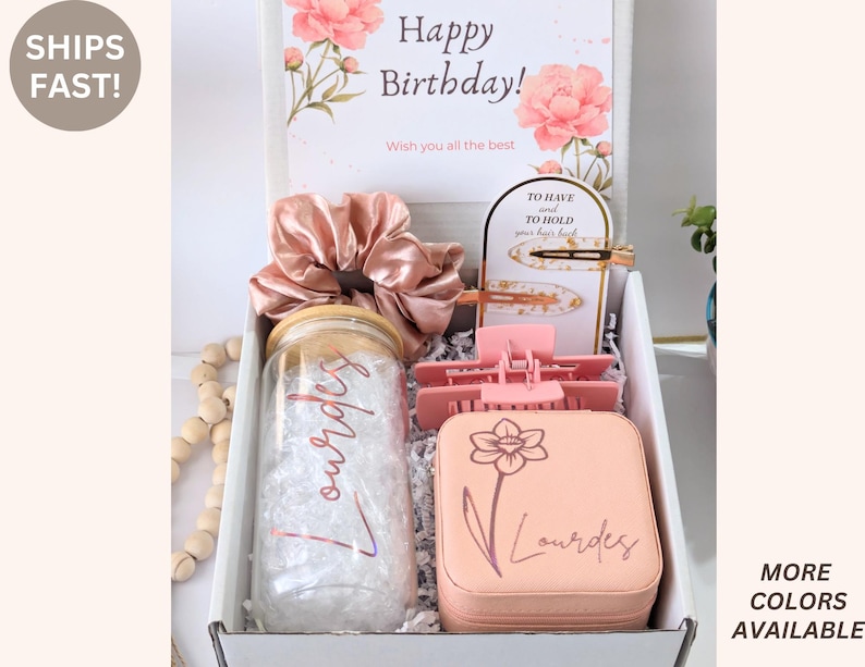 May include: A gift box with a birthday card, scrunchie, hair clips, and a personalized jar and jewelry case. The card reads "Happy Birthday!" and "Wish you all the best." The jar and case are personalized with the name "Lourdes."