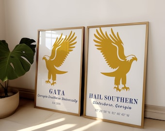May include: Two framed prints with a gold frame. The prints feature a yellow eagle with outstretched wings. The left print has the text "GATA Georgia Southern University Est 1906". The right print has the text "HAIL SOUTHERN Statesboro, Georgia 32° 26' 56" N 81° 46' 40" W".