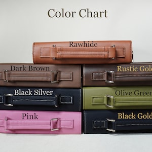 May include: A stack of six leather-bound books with different colored covers. The colors are rawhide, dark brown, black silver, olive green, pink, and black gold. The books have a handle on the top and are stacked on a white surface.