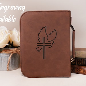 May include: Brown leather Bible cover with a dove and cross design. Back Engraving Available.