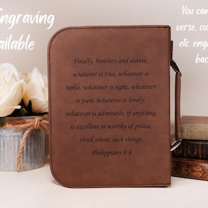 May include: A brown leather bible cover with a quote from Philippians 4:8 engraved on the back. The quote reads "Finally, brothers and sisters, whatever is true, whatever is noble, whatever is right, whatever is pure, whatever is lovely, whatever is admirable, if anything is excellent or worthy of praise, think about such things. Philippians 4:8".