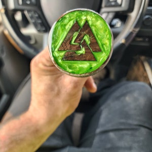 May include: A green and brown wooden knob with a triangular design. The knob is made of wood and has a green epoxy finish.