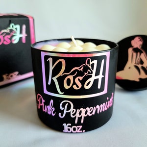 May include: A black candle jar with a white lid and a pink and black label that says "RosH Pink Peppermint 16oz."
