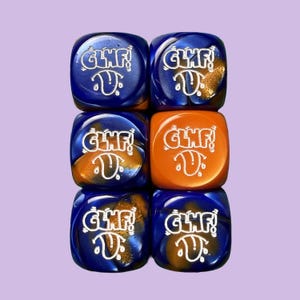 May include: Six dice with the text "GLMF!" and a tongue graphic. The dice are blue and orange with gold accents. The dice are arranged in two columns of three.