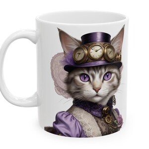 May include: White ceramic mug featuring a steampunk cat illustration. The cat wears a purple top hat with clock-face goggles, a purple outfit, and has purple eyes. The design is detailed and whimsical, perfect for cat lovers.