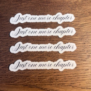 May include: Four white stickers with the text "Just one more chapter" written in black cursive script.