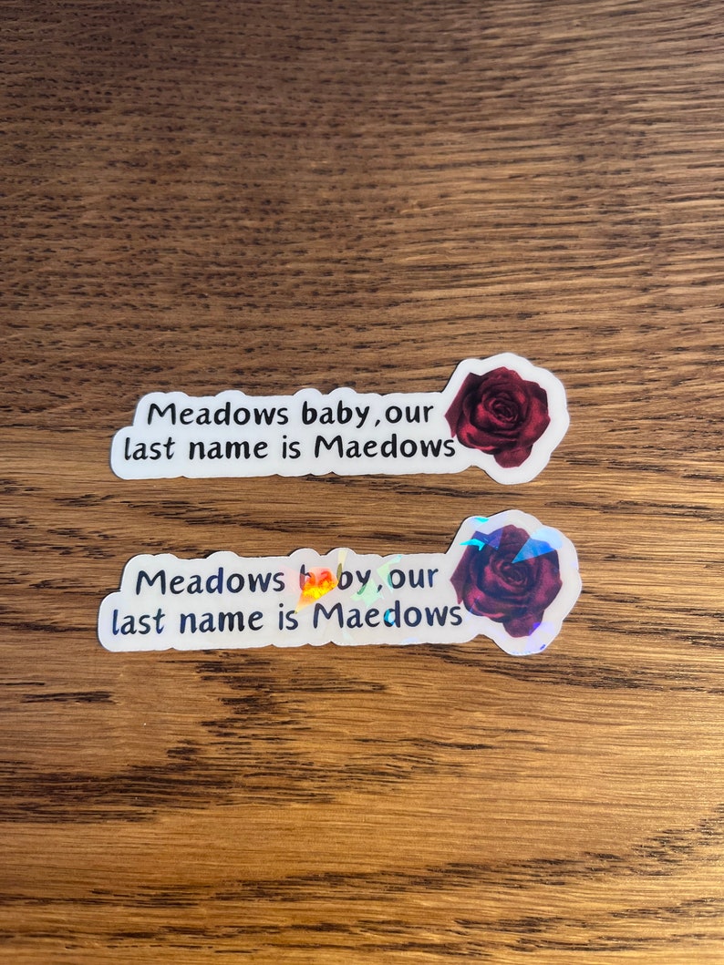 May include: Two stickers with a red rose and the text "Meadows baby, our last name is Maedows".