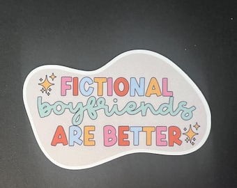 May include: A sticker with the text "FICTIONAL boyfriends ARE BETTER" in colourful bubble letters and a retro font. The sticker has a light grey background and star accents.