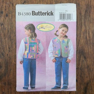 May include: Butterick sewing pattern B4380 for a quilted vest. The envelope features text and illustrations of a child wearing a colorful patchwork vest over a white long-sleeve shirt and blue jeans, shown from both the front and back views.