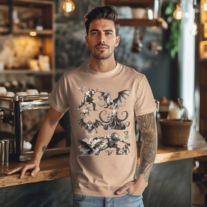 Male model with tattoo in one arm wearing Heather Sand dune short sleeve shirt standing over a counter at a store with one arm in jean pockets