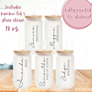 May include: Set of five 18 ounce white frosted glass tumblers with bamboo lids and glass straws. Each tumbler is personalized with a name and title, such as "Bride", "Maid of Honor", and "Bridesmaid". The tumblers are fully printed, not stickers.