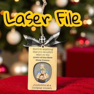 May include: Wooden ornament with the text "Laser File" in yellow. The ornament has a black and white checkered bow and a string for hanging. The ornament has text and an illustration of a couple. The text reads "Don't do anything that you wouldn't want on the cover of the New York Times."