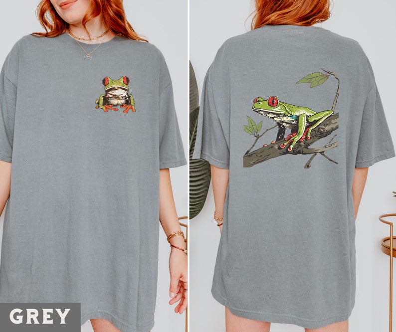 May include: Two gray t-shirts with a green tree frog graphic. One shirt has the frog on the front and the other has the frog on the back.