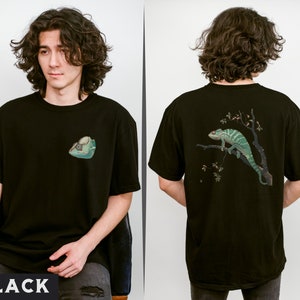 May include: Black t-shirt with a green chameleon graphic on the back and a small green lizard graphic on the front. The t-shirt is made of a soft, comfortable material.