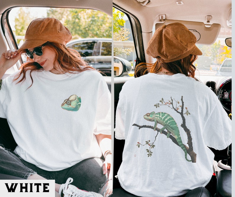 May include: White t-shirt with a chameleon graphic on the front and a chameleon on a branch graphic on the back.