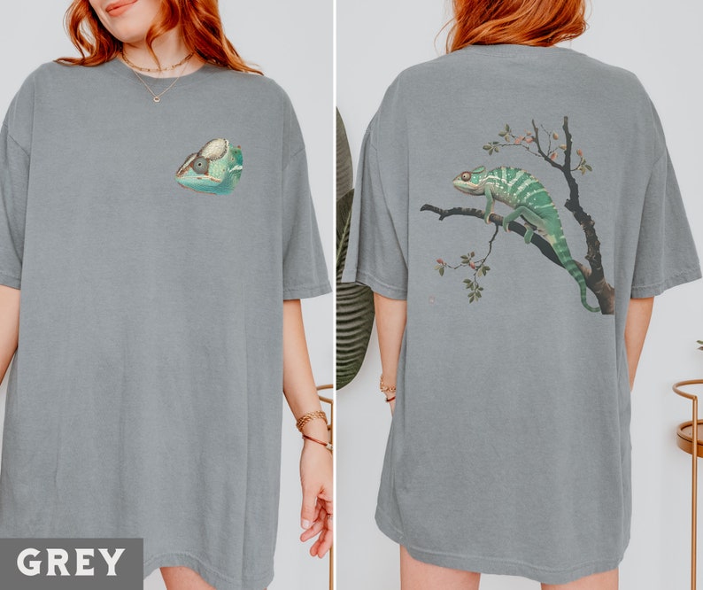 May include: Two grey t-shirts with a chameleon graphic. One shirt features a chameleon on a branch with flowers, the other shirt features a chameleon head.