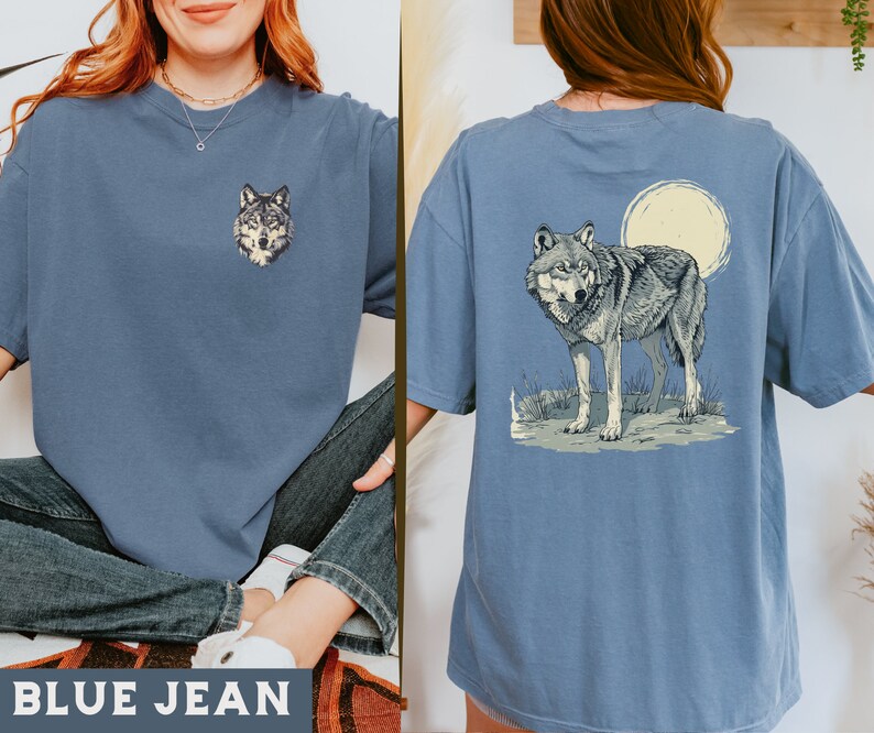 May include: A blue jean t-shirt with a wolf graphic on the front and a wolf howling at the moon graphic on the back.