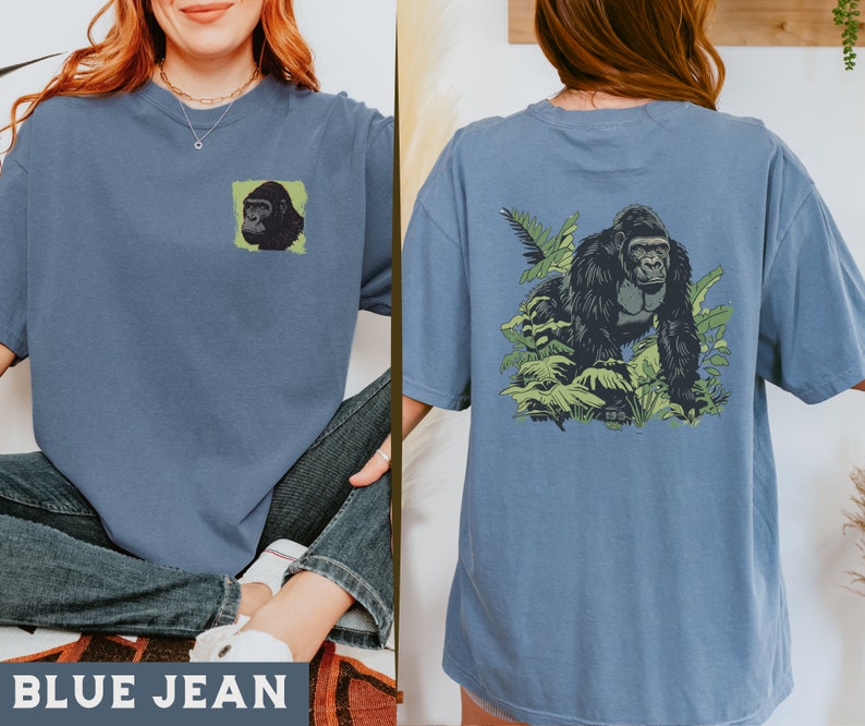 May include: A blue jean t-shirt with a gorilla graphic on the front and a gorilla graphic in a jungle scene on the back. The text "BLUE JEAN" is printed on the bottom of the image.
