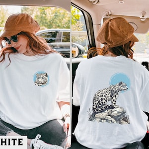 ユキヒョウシャツ、ユキヒョウグラフィックTシャツ、自然からインスピレーションを得たヒョウトップ、ユニークな大型猫のデザイン、ユキヒョウ愛好家へのギフト