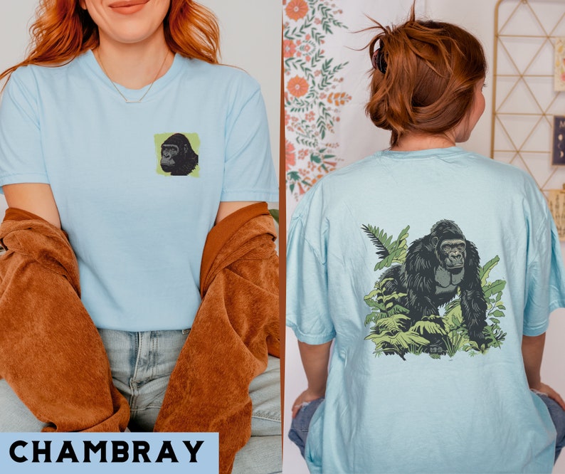 May include: Two light blue t-shirts with a gorilla graphic print. The first shirt features a close-up of a gorilla's face. The second shirt features a gorilla walking through a jungle scene.