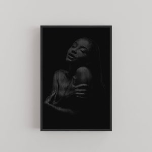 May include: A black and white digital art print of a person with long hair, looking up and holding their arms around themselves.