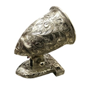 May include: A silver-plated, decorative,  ornate,  leaf-patterned,  metal  wall  sconce  with  a  curved  design.