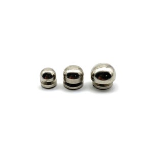 May include: Three silver metal dome-shaped knobs of varying sizes.