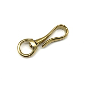 May include: A gold-toned metal swivel hook with a round ring on one end and a curved hook on the other end.