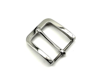 May include: A shiny, silver-colored belt buckle with a rectangular frame and a single bar. The buckle is made of metal and has a polished finish. The design is simple and classic, suitable for various belt styles.