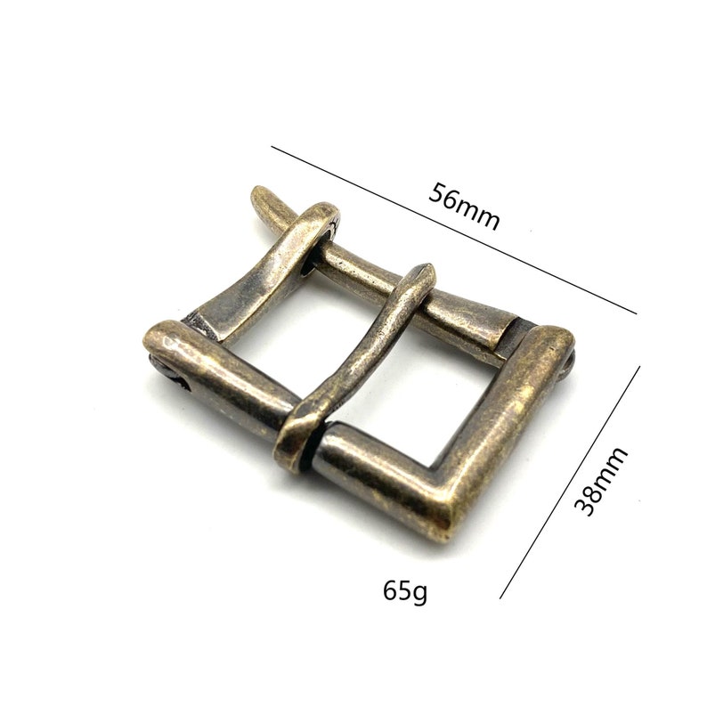 May include: A brass buckle with a rustic finish, measuring 56mm by 38mm and weighing 65g.