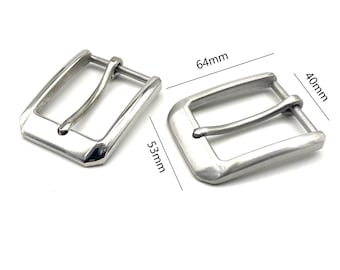 May include: Two silver metal belt buckles. The buckle on the left measures 13.5 cm long and the buckle on the right measures 16.3 cm long and 10.2 cm wide.