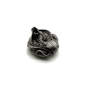 May include: A detailed, silver-coloured snake figurine, coiled in a defensive posture with its hood flared and mouth open. The sculpture has textured scales and is set against a white background.