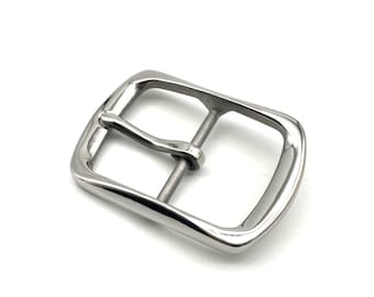 May include: A silver metal belt buckle with a smooth, rounded finish.