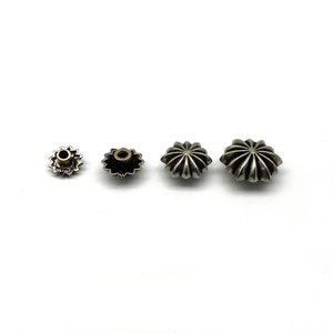 May include: Three silver star-shaped metal studs of different sizes. The studs have a raised, textured design and a small hole in the center.