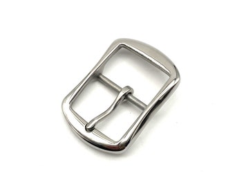 May include: A silver metal buckle with a smooth, rounded finish. The buckle has a rectangular shape with a curved top and bottom.