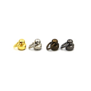 May include: Four swivel snap hooks with a round base. The hooks are in four different finishes: gold, silver, bronze, and black.