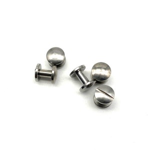 May include: Five silver metal screw-in fasteners with a round head and a threaded post.