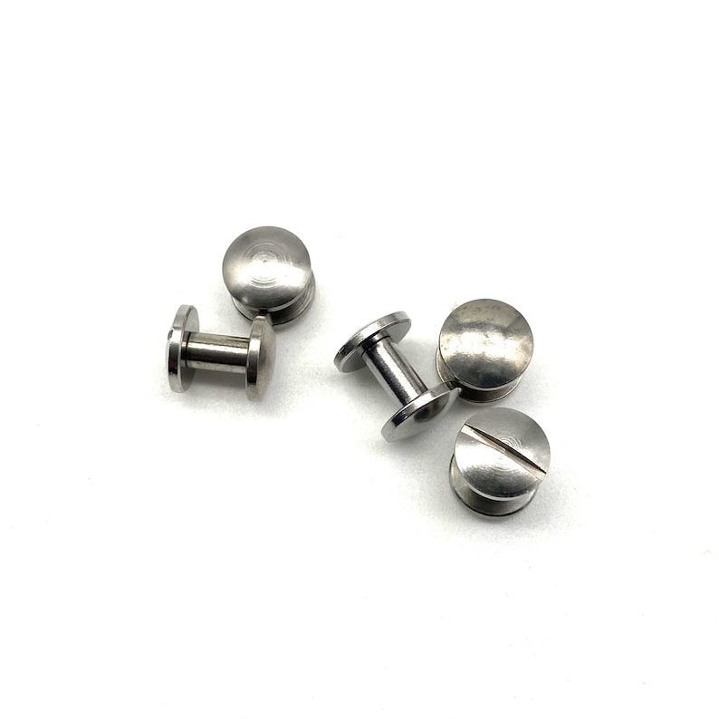 May include: Five silver metal screw-in fasteners with a round head and a threaded post.