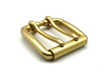 May include: A solid brass belt buckle with a rectangular frame and a central bar. The buckle has a classic design with a polished, golden finish. The hardware is suitable for leather belts and other crafting projects.
