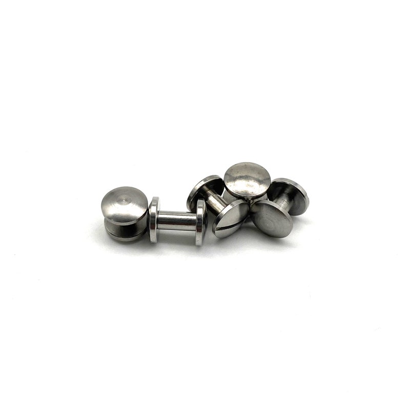 May include: A close-up of five silver metal screw-in fasteners. The fasteners have a round head and a threaded shaft.