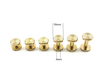 May include: Five gold-colored metal studs with a starburst design. The studs are 10 mm in diameter and 4 mm in height.