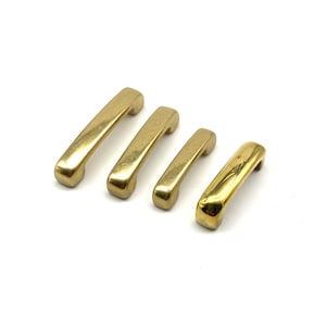 May include: Four gold-toned metal cabinet pulls in different sizes. The pulls are all the same shape, with a rounded rectangular body and a slight curve at the top.