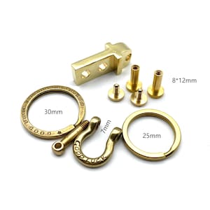 May include: A brass key chain kit with a 30mm round ring, a 7mm D-ring, a 25mm round ring, and four brass screws. The kit includes the text "Good Luck Rolling Co. Ltd."