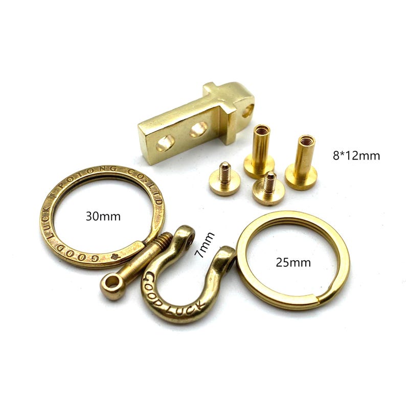 May include: A brass key chain kit with a 30mm round ring, a 7mm D-ring, a 25mm round ring, and four brass screws. The kit includes the text "Good Luck Rolling Co. Ltd."