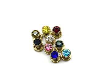 May include: Assortment of ten small round metal buttons with colorful rhinestones. The buttons are gold-toned and feature a variety of colors including red, blue, green, yellow, black, pink, and clear.