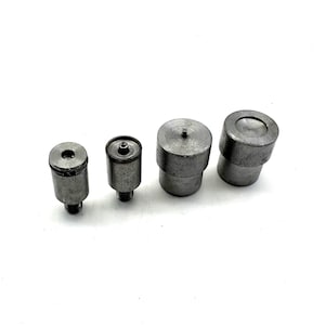 May include: Four silver metal snap fasteners of different sizes. The fasteners are used for attaching fabric or leather together.