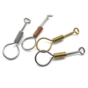 May include: Three keychains with a loop at the end and a coiled metal spring in the middle. The keychains are silver, gold, and copper.