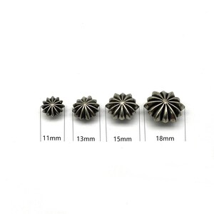 May include: Four silver star-shaped metal studs in different sizes: 11mm, 13mm, 15mm, and 18mm.