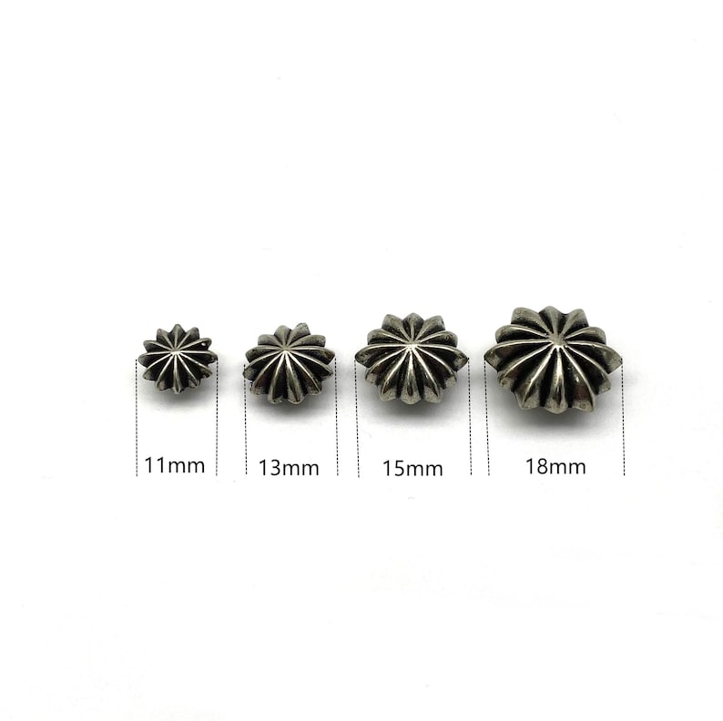 May include: Four silver star-shaped metal studs in different sizes: 11mm, 13mm, 15mm, and 18mm.